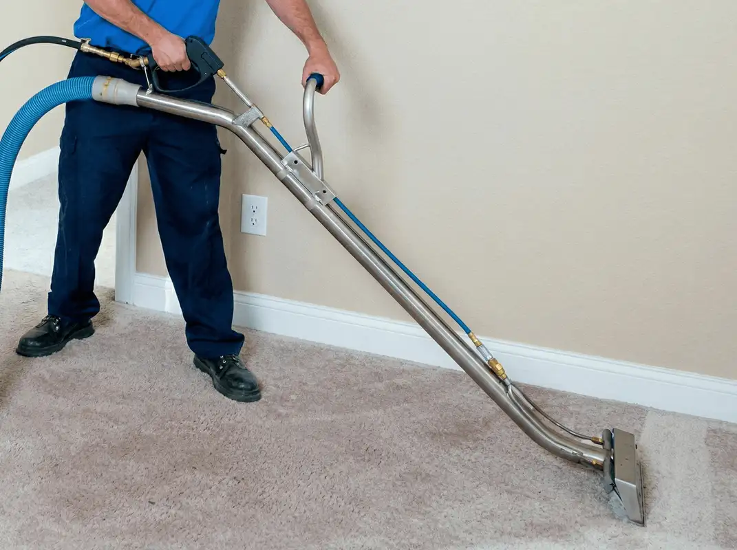Professional operating a liquid removal machine on a carpeted floor in Jacksonville, FL